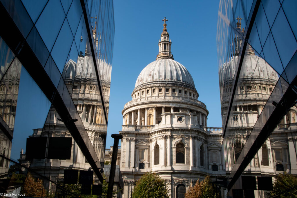 A view of St Paul's Cathedral from One New Change on a sunny day with blue skies.