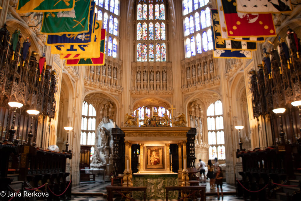 Interior of the Lady Chapel at Westminster Abbey with a painting of the Virgin and Child, statues of saints and stained glass windows