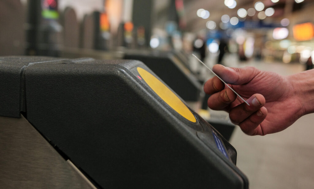 A card being tapped on the yellow card reader on London Underground.