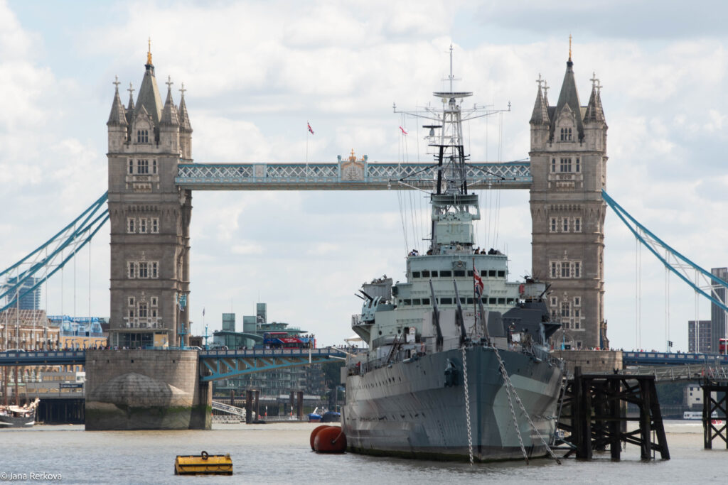 Warship HMS Belfast on River Thames in London with the Tower Bridge in the background