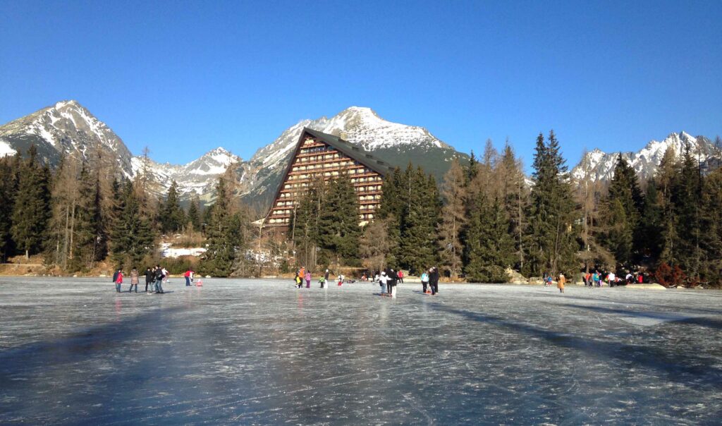 Frozen Strbske Pleso (lake) in the High Tatras in Slovakia with the hotel Patria in the background