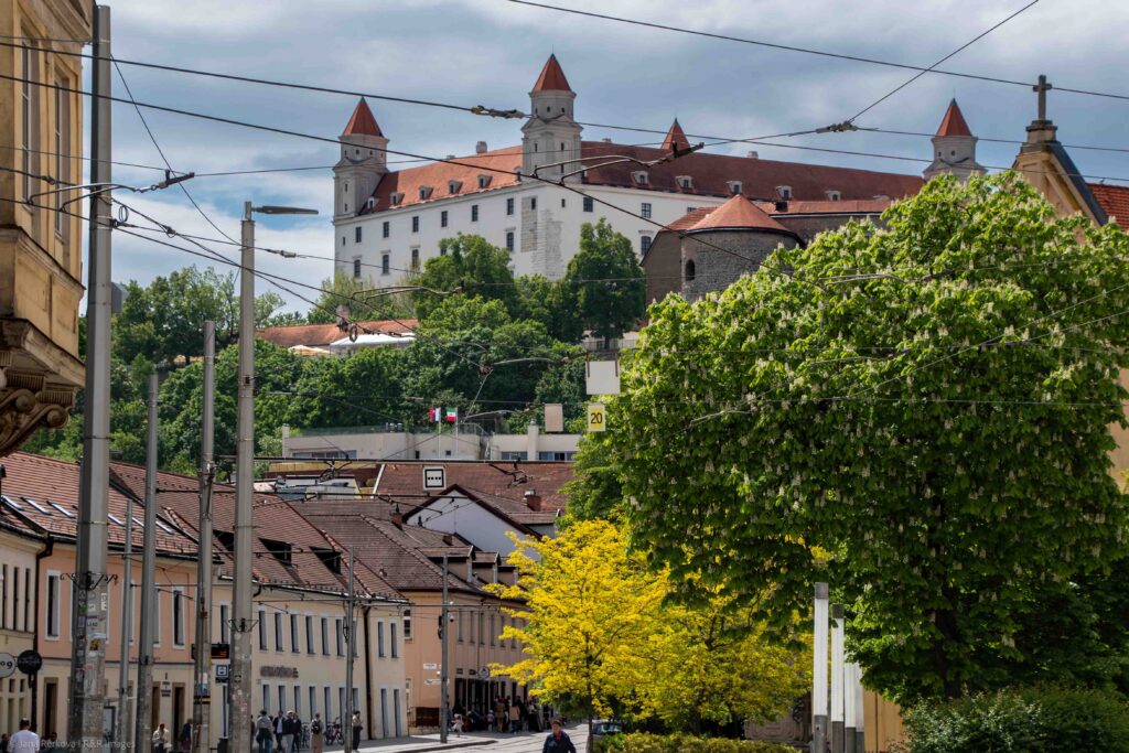 City view of Bratislava Castle perched on a rocky hill overlooking the surrounding urban buildings