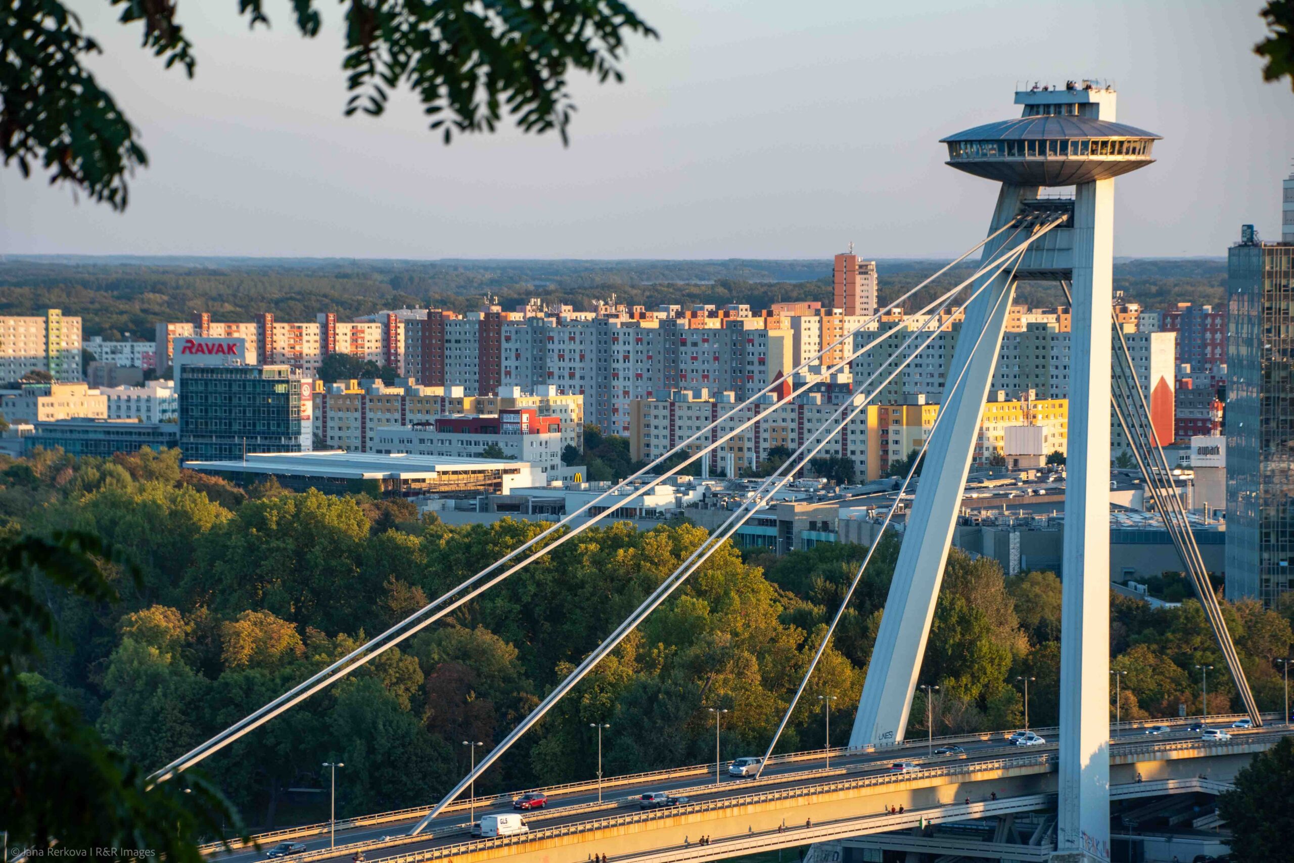 View of the iconic UFO tower on top of the Most SNP bridge with Petržalka in the background.